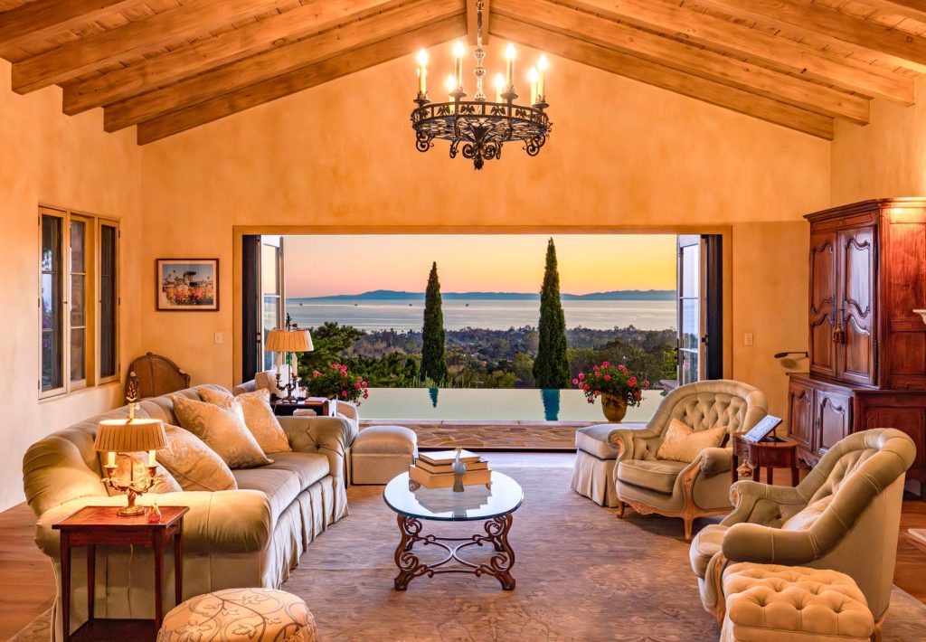 Living room at 965 Brooktree Road with folding doors open to an ocean view at sunset